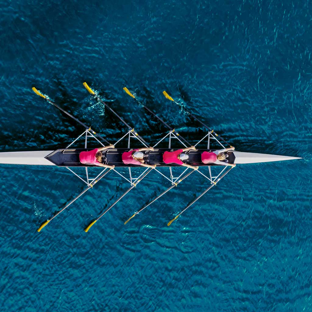 Sapien Global Services | Outsourced Finance Director Services. Showing a row boat team.